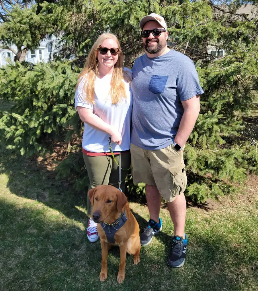 The author and her husband standing next to their dog