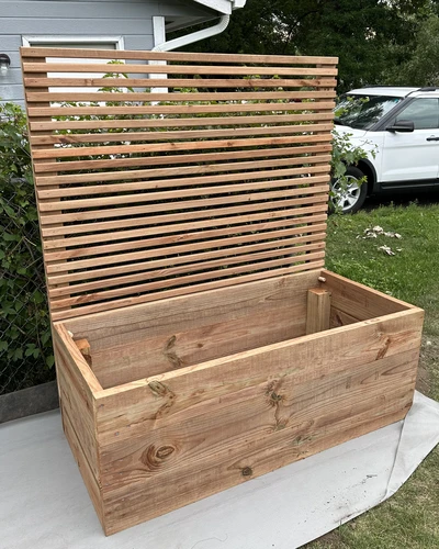 front view of a completed raised garden bed with privacy panel that has not been stained or filled with dirt yet.