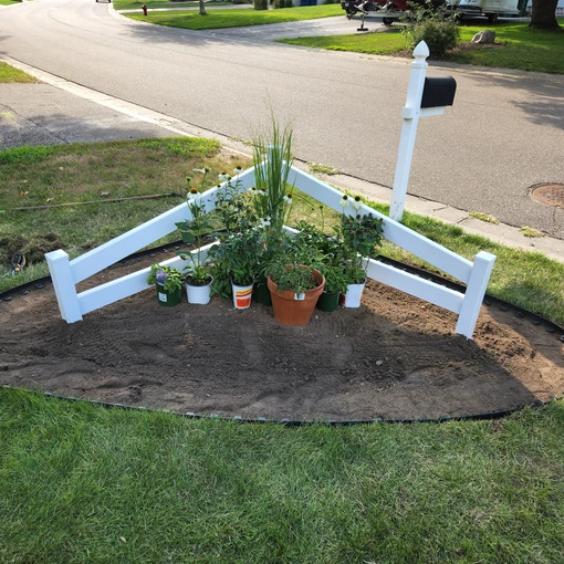 a white fence with plants in it