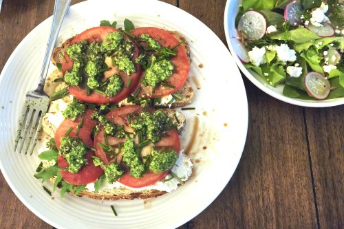 Caprese toast topped with pesto made from radish greens and side salad with sliced radishes, made from the garden during an early spring harvest.