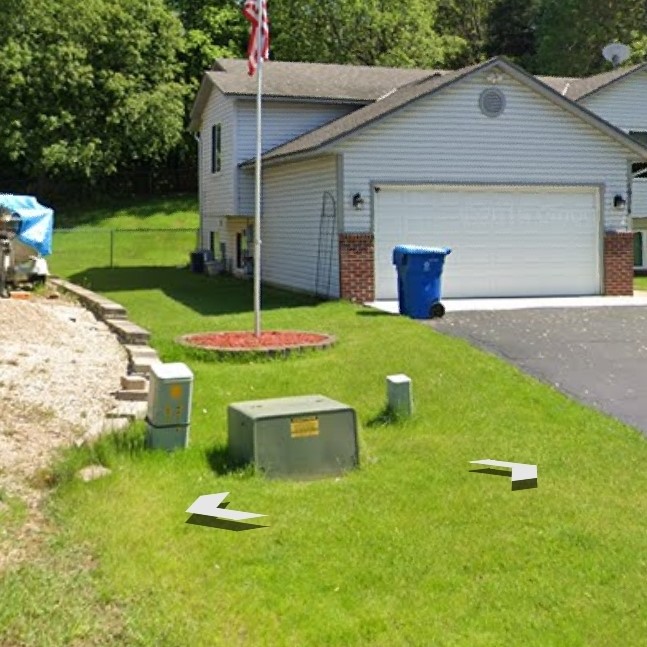 view of side yard with utility box and grass